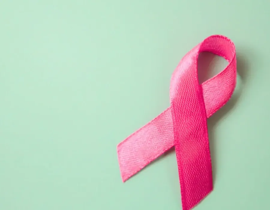 Pink ribbon pinned against green board